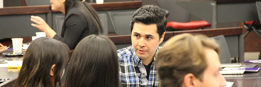 law student in a classroom talking with other students